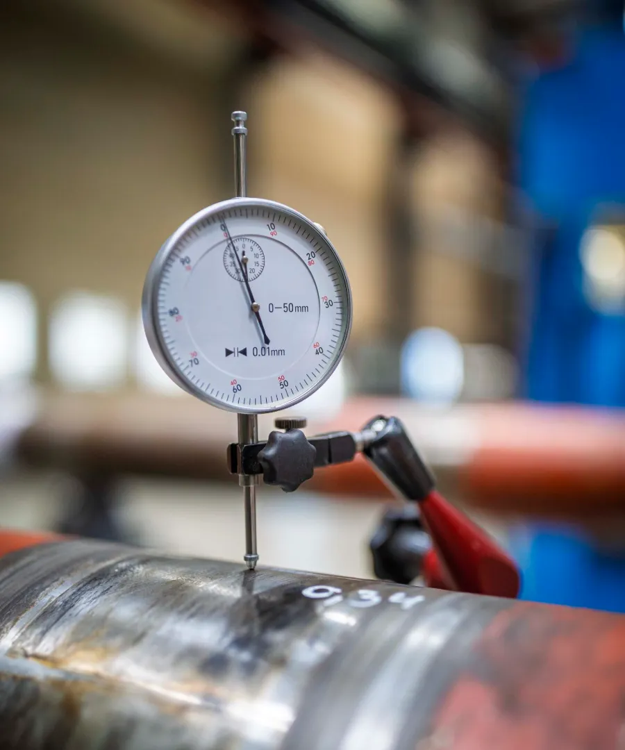 Dial gauge measuring the run-out of a propeller shaft after straightening
